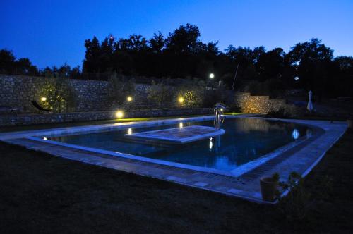 a swimming pool in a yard at night at Agriturismo Borghetto Il Montino in Rapolano Terme