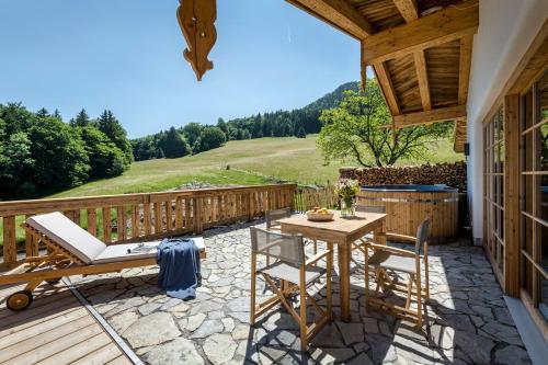 a patio with a table and chairs on a deck at Chiemsee Chalet in Frasdorf