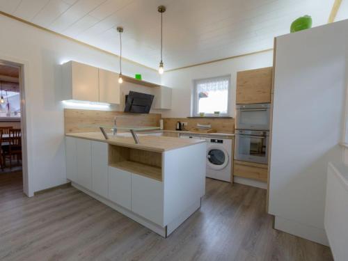 a kitchen with white cabinets and a counter top at Landhaus Hillebrand in Trendelburg