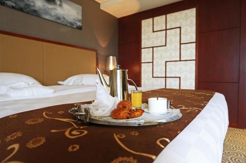a tray of food on a table in a hotel room at Hôtel Huatian Chinagora in Alfortville