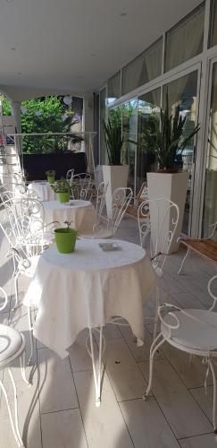 a group of tables and chairs in a room at Hotel Britannia Rimini Marina centro in Rimini