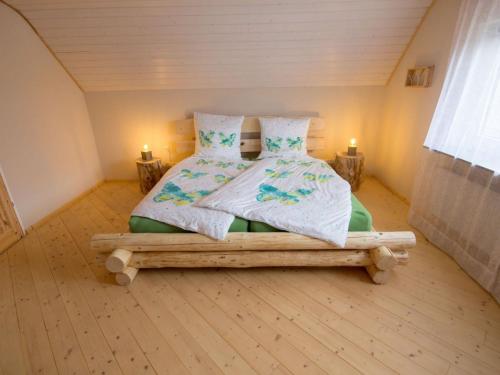 a bedroom with a bed with two pillows at Landhaus Hillebrand in Trendelburg