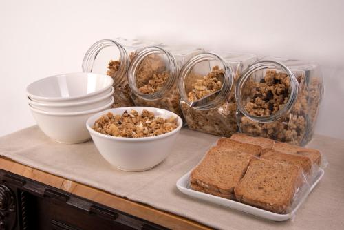 a table topped with bowls of food and bread at Cascina36 B&B in Pregnana Milanese