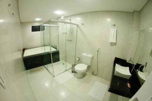 a bathroom with a shower and a toilet at LW Hotel in Arcoverde