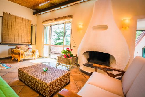 a living room with a large fireplace in the center at Belvedere di Gloria in Tramonti