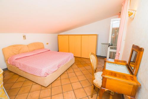 a bedroom with a bed and a mirror and a chair at Belvedere di Gloria in Tramonti
