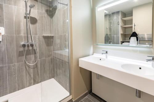 a bathroom with a sink and a shower at ibis Saint Malo Plage in Saint Malo