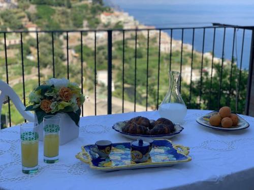a table with two plates of food and a glass of milk at Lucy's house - comfortable apartment in Amalfi in Amalfi