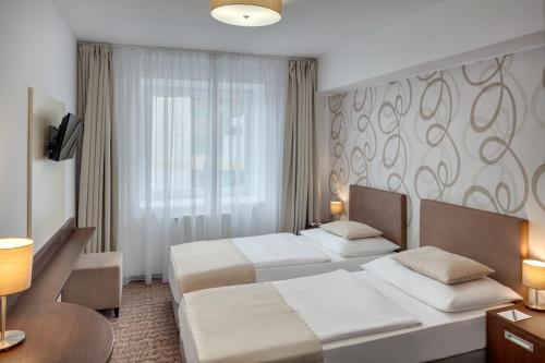 Säng eller sängar i ett rum på Hotel Atlas
