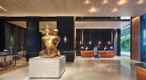 a bronze statue of a woman in a lobby at Hyatt Regency Bangkok Sukhumvit in Bangkok