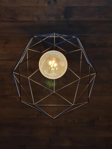 a ceiling light with a hexagonal design on it at Dannunziano Aparthotel in Chieti