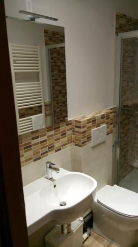 a bathroom with a sink and a toilet and a mirror at Accanto al Duomo in Florence