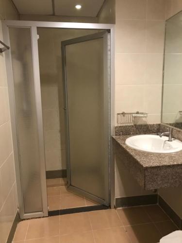 a bathroom with a shower and a sink at Floral Shire Suvarnabhumi Airport in Lat Krabang