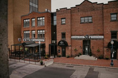 a brick building with a restaurant on a street at St. James' Gate, Boutique Hotel in Moncton