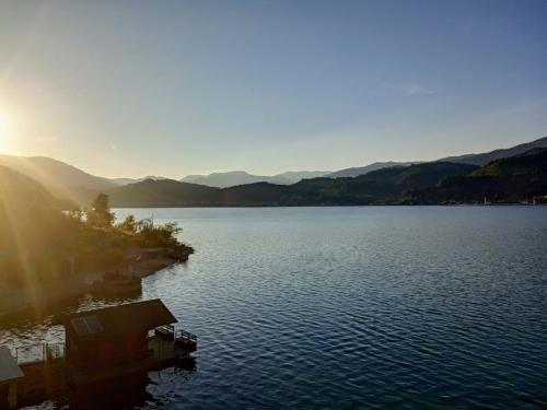 a view of a large body of water with mountains in the background at Dina apartman Jablaničko jezero in Konjic