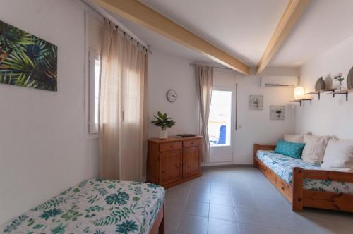 um quarto com uma cama e uma cama e uma janela em Lets Holidays Apartment Tossa Near Beach 2 em Tossa de Mar
