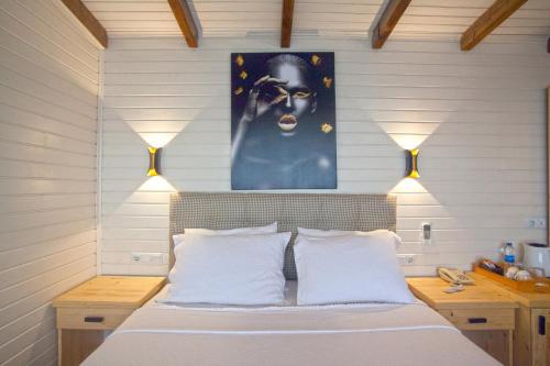 
a bedroom with a bed and a painting on the wall at Sunset Villa Hotel in Kaş
