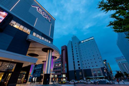 a group of buildings in a city at night at Hotel Wing International Asahikawa Ekimae in Asahikawa
