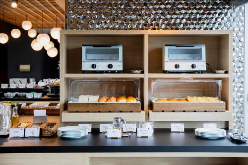 a bakery counter with pastries and other food items at Hotel Wing International Asahikawa Ekimae in Asahikawa
