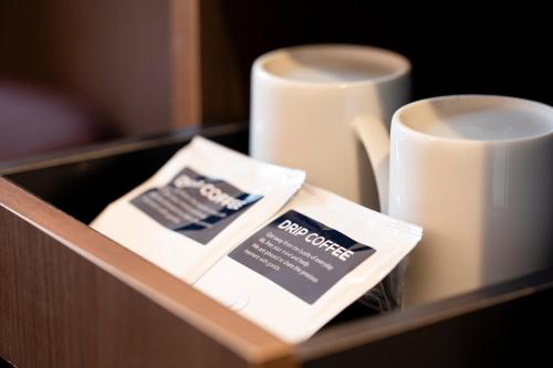 a drawer with two cups and a box of tea at Hotel Wing International Asahikawa Ekimae in Asahikawa