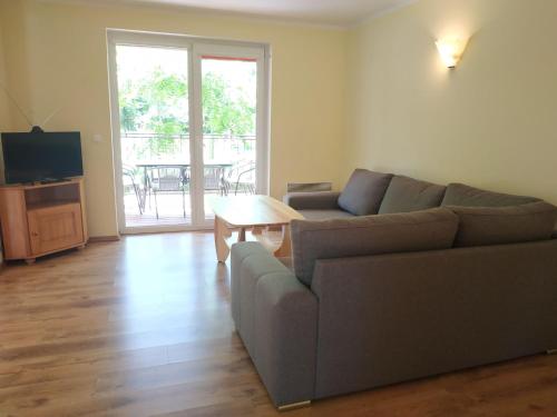 a living room with a couch and a table at Lake Park Łagów in Łagów