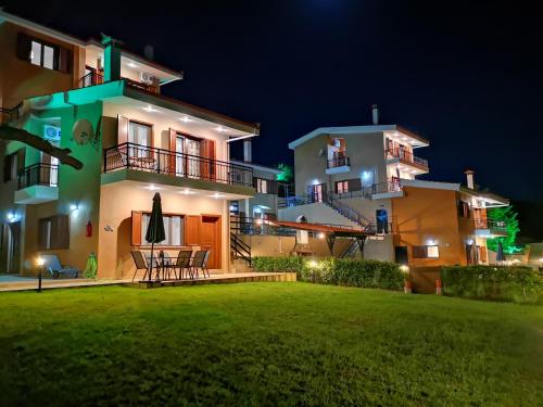 a house with a lawn in front of it at night at Seaview Villas in Vourvourou