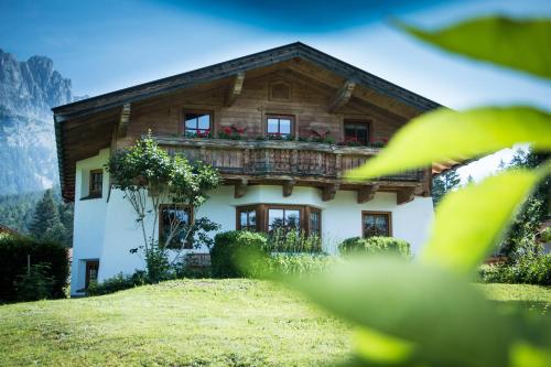 a house with a balcony on top of it at Chalet Glücklich sein... in Ellmau