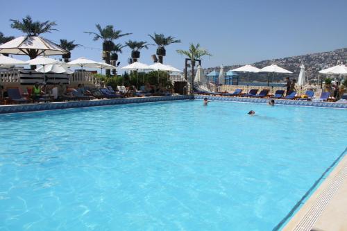 a large swimming pool with people in the water at Lamedina Hotel & Resort in Jounieh