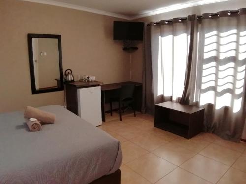 Postel nebo postele na pokoji v ubytování Goedehoop Guesthouse