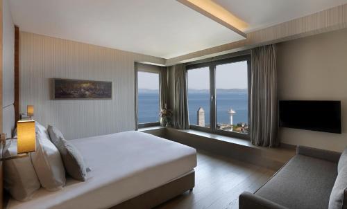 a hotel room with a bed and a large window at Hotel Arcadia Blue Istanbul in Istanbul