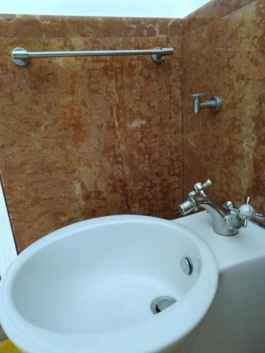 a bathroom with a white sink and a toilet at Olivella Suite Ecological House in Palermo