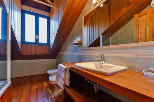 a bathroom with a sink and a toilet at Casa Rural La Chata by Vivere Stays in Valsain