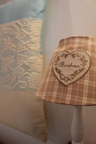 a pillow with a heart on a table at B&B Piazza di L'Ara in Tempio Pausania