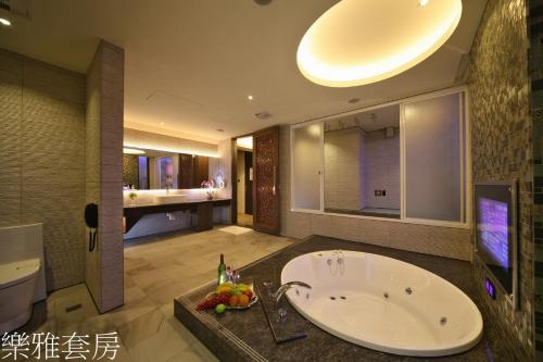 a bathroom with a large tub and a sink at Doule Motel in Taichung