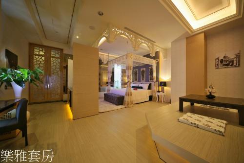 a large room with a bed and a table in it at Doule Motel in Taichung