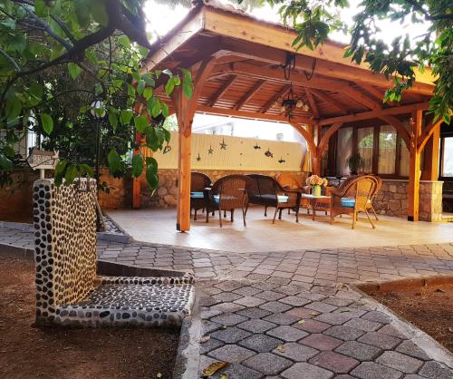 a wooden pavilion with chairs and a table at İlkiz Beach Hotel in Oludeniz