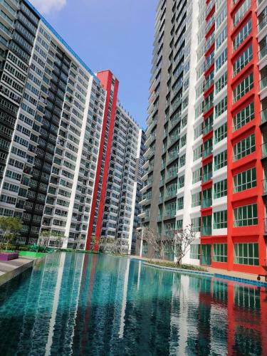 two tall buildings with a pool of water between them at The Zizz Homestay@Damansara Damai in Petaling Jaya