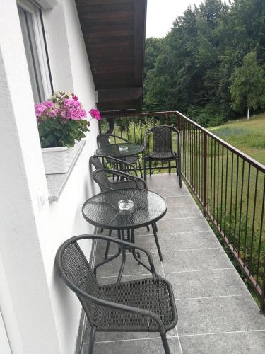 a row of tables and chairs on a balcony at New apartment near Plitvice lakes in Smoljanac
