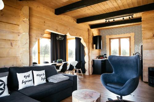 a living room with a couch and a chair at Bajka Hotel & Resort in Grodziec