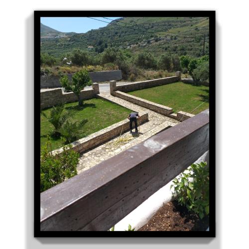 a person standing on a bench looking at a park at Natural Green Apartment in Dhamnóni