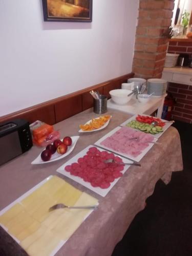 a kitchen counter with fruits and vegetables on a table at Penzion U Papoušků in Jindrichuv Hradec