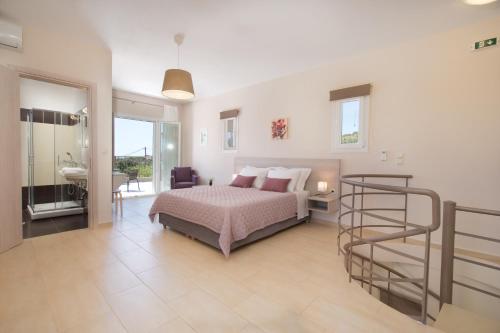 a large bedroom with a bed and a bathroom at Rose Maisonette in Kefallonia