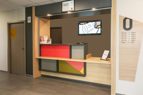 a store with a colorful counter in a room at B&B HOTEL Les Herbiers in Les Herbiers