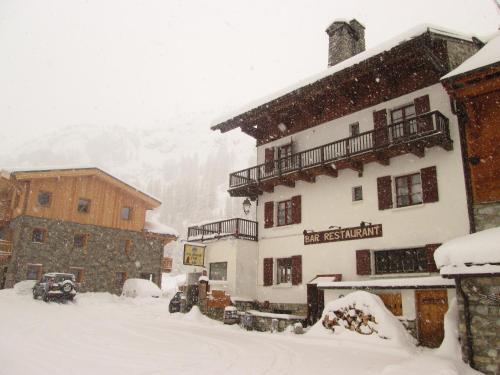 a snow storm in the mountains with a building at Le Dôme in Tignes