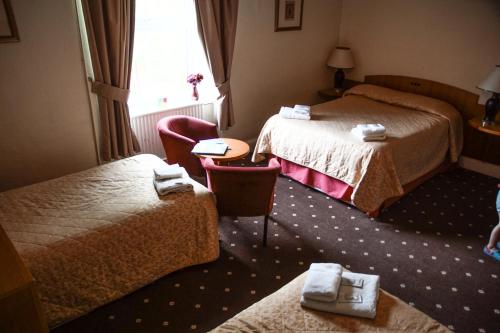 Ένα ή περισσότερα κρεβάτια σε δωμάτιο στο Abbey Grange Hotel
