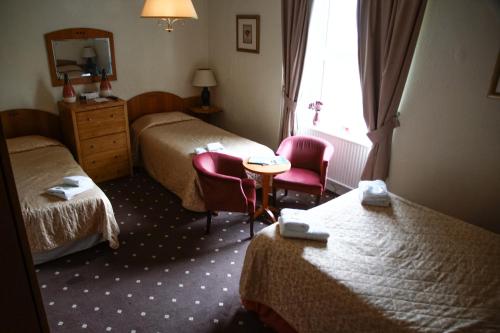 Ένα ή περισσότερα κρεβάτια σε δωμάτιο στο Abbey Grange Hotel