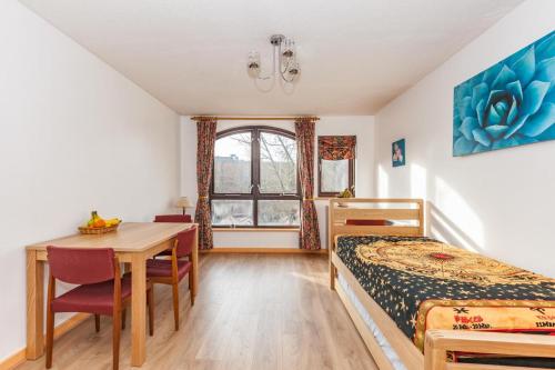 a bedroom with a bed and a table and a desk at NEW Bright and Sunny flat in Oxford City Centre in Oxford