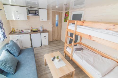 a small room with a bunk bed and a table at Twój Zakątek pod Zatorem in Zator