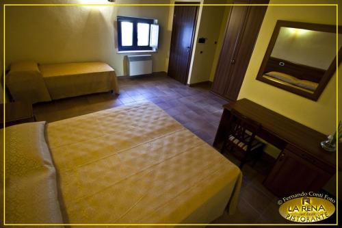 a hotel room with a bed and a mirror at Villa La Rena in Anagni