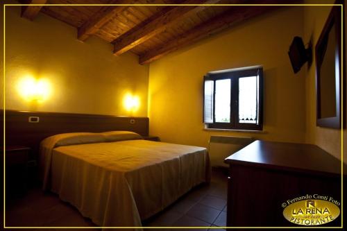 a bedroom with a bed and a window at Villa La Rena in Anagni